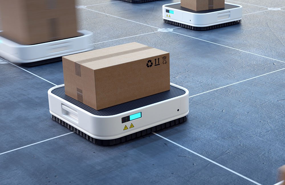 A mobile robot with a box on it moving through the warehouse.