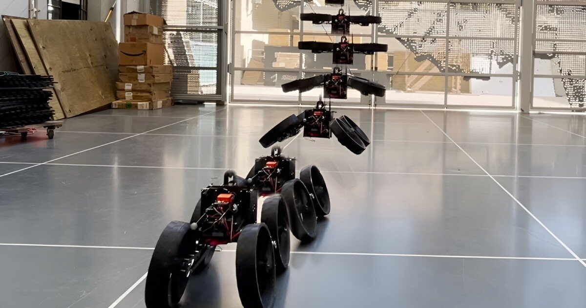 The flying robot morphs in the center of the air to land and roll on the wheels